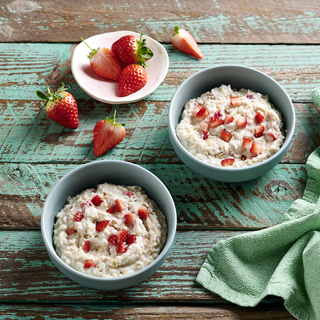 bowl of Quaker oats porridge with strawberries and yogurt in a bowl