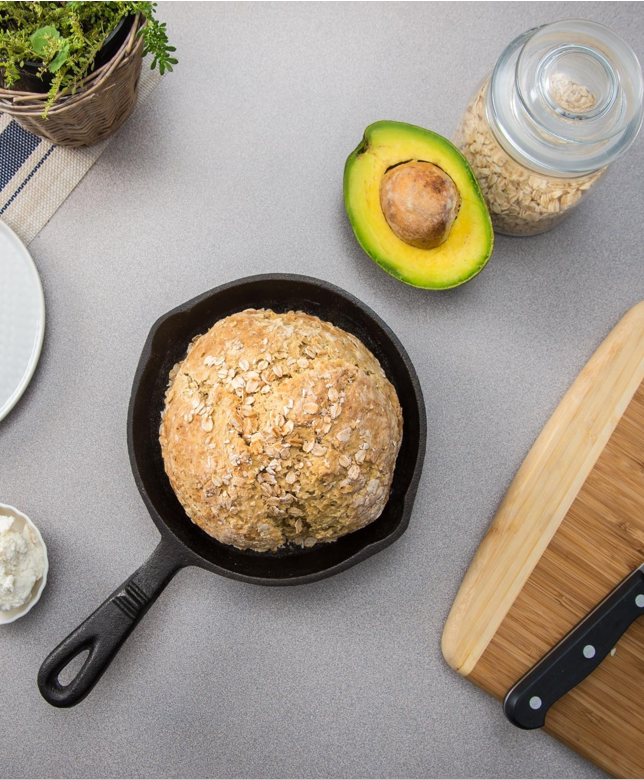oat bread on frying pan with avocado on the side