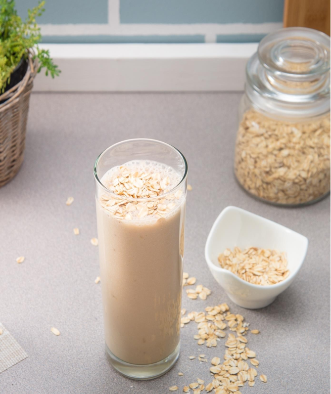 glass of coffee breakfast smoothie topped with oats