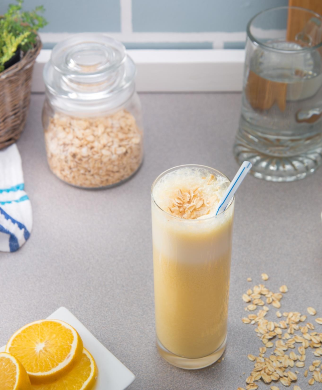 orange, oat & milk smoothie in a glass